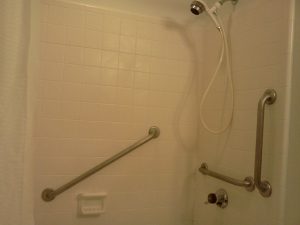 THREE STAINLESS STEEL BARS ON SHOWER TILE WALLS