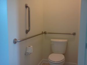 STAINLESS STEEL GRAB BARS IN COMMERCIAL RESTROOM