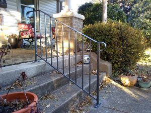 CUSTOM WROUGHT IRON HANDRAILL CENTERED ON WIDE STEPS